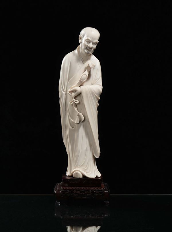 A carved ivory depicting Luohan with ruyi, China, early 20th century