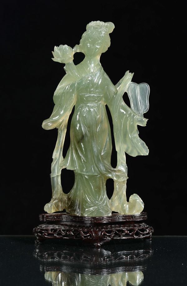 A green jade figure of Guanyin with a wooden base, China, Republic, 20th century