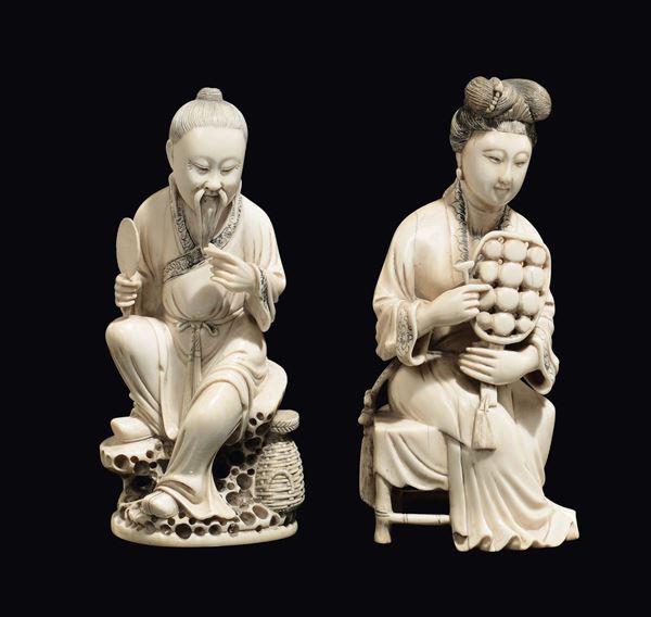 A pair of Guanyin and dignitary with fan in carved ivory, China, Qing Dynasty, 19th century