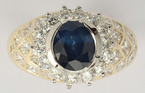 A sapphire, diamond and gold ring