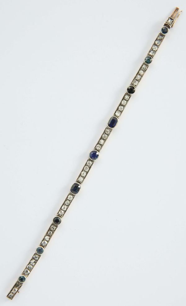 A sapphire, old cut diamond, silver and gold bracelet