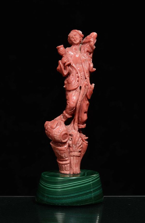 A coral yougster with barrel on malachite base, China, early 20th century