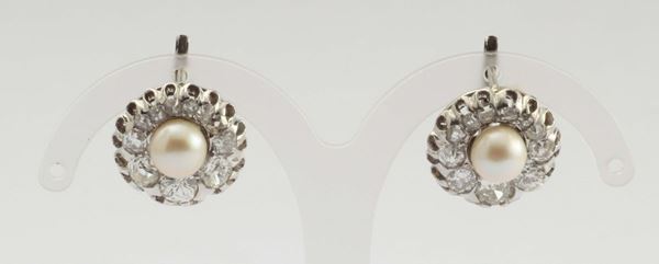 A pair of pearl and diamond earrings. 1930