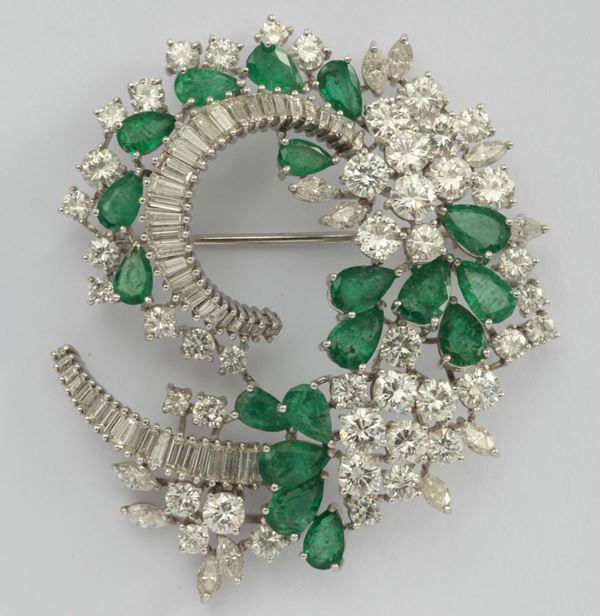 A diamond, emerald and platinum spray brooch. 1950