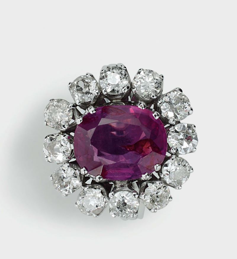 A ruby and diamond ring. The central cushion-shaped ruby, weighing 4,19 carats. Accompanied by a report from R.A.G. Torino, stating that the ruby is of Burmese (Myanmar) origin and no evidence of heat and clarity enhancements. Report number  - Auction Fine Jewels - I - Cambi Casa d'Aste