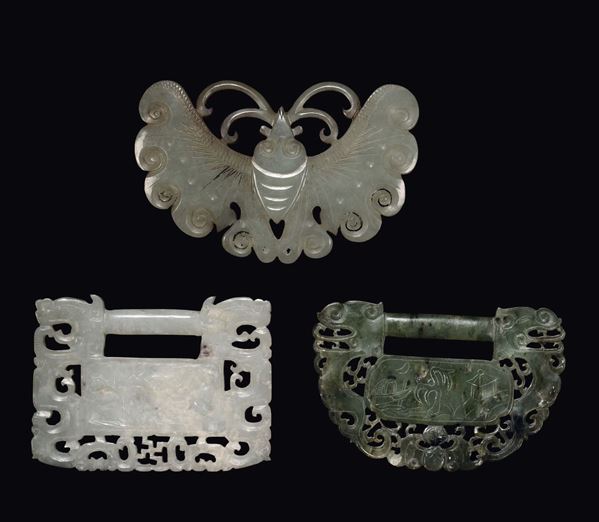 A Celadon jade butterfly and two buckles, a spinach one and a Celadon one, China, Qing Dynasty, 19th century