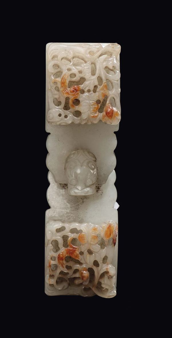 A carved white jade and fretworked russet buckle, China, Qing Dynasty, Qianlong period (1736-1796)