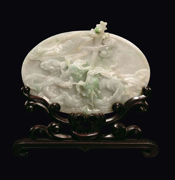 An oval white and green jadeite plate carved with dragons, China, Qing Dynasty, late 19th century