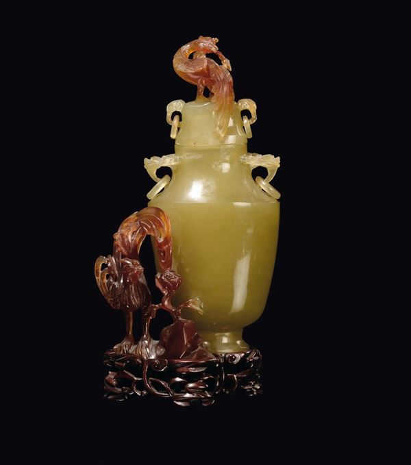 A small yellow and brown jade vase and cover with peacock representations, China, Republic, 20th century