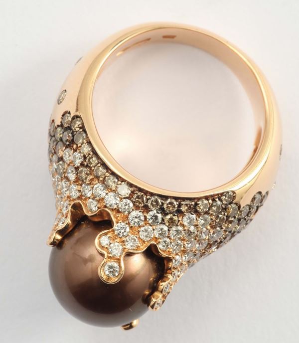A cultured pearl and diamond ring. By Brarda
