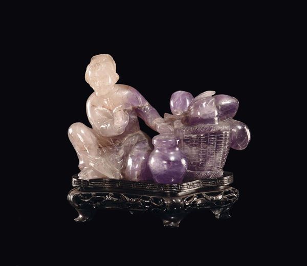 An amethyst Guanyin with a fruit basket, China, early 20th century