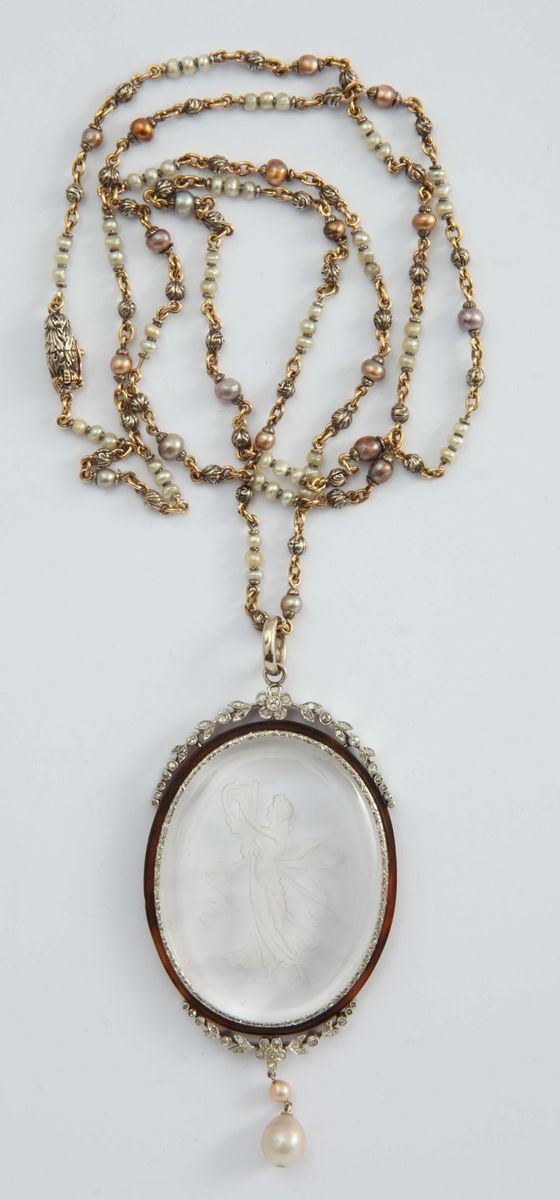 An engraved rock crystal pendant with a sedds pearl, gold and sillver necklace