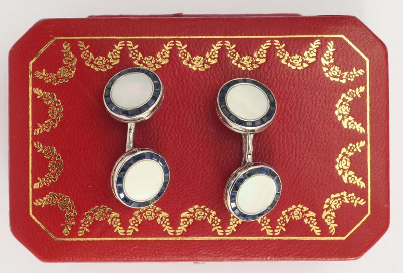 A mother of pearl, sapphire and platinum cufflinks. Signed and numbered Cartier Paris 128050  - Auction Fine Jewels - I - Cambi Casa d'Aste