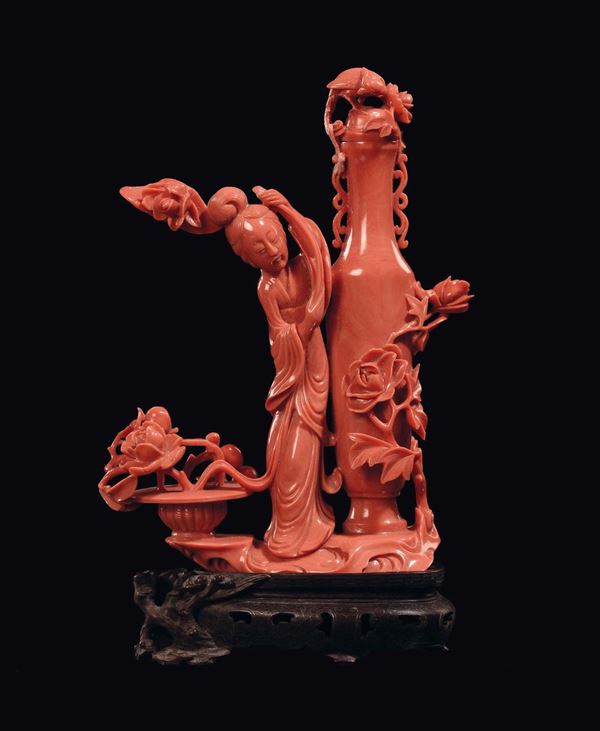 A coral Guanyin with bottle and flowers, China, Qing Dynasty, late 19th century