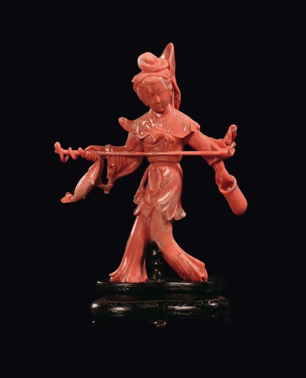 A coral Guanyin with rod and fish, China, Qing Dynasty, early 20th century