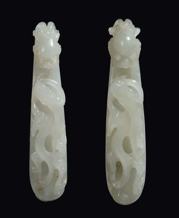 A pair of white jade small dragon buckles, China, Qing Dynasty, Qianlong period (1736-1796)