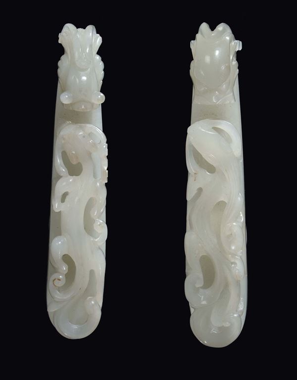 A pair of white jade small dragon buckles, China, Qing Dynasty, Qianlong period (1736-1796)