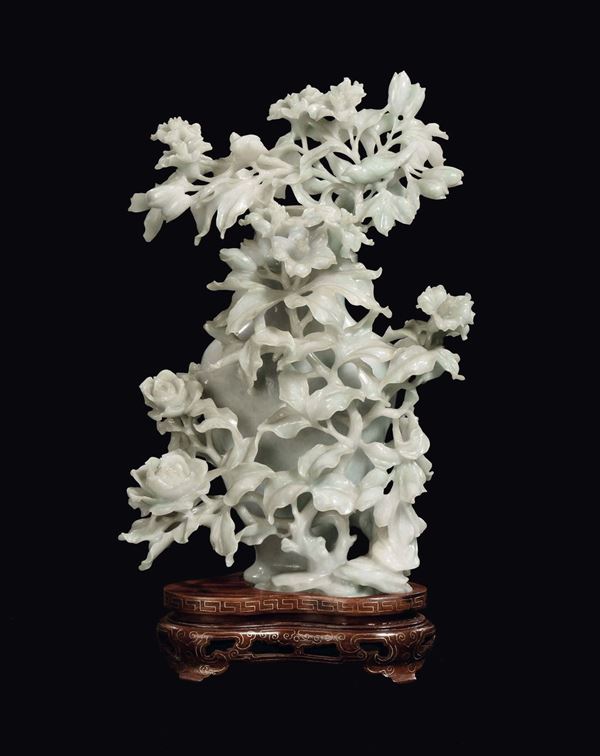 A Celadon jade vase richly carved with relief blooming branches, China, early 20th century