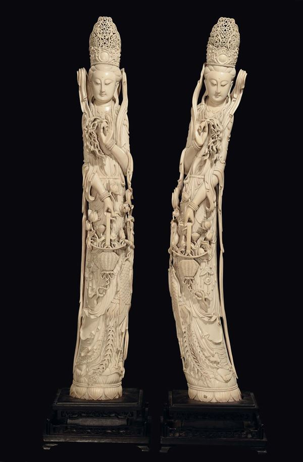 A pair of Guanyin with basket and flowers in carved ivory, China, Qing Dynasty, late 19th century
