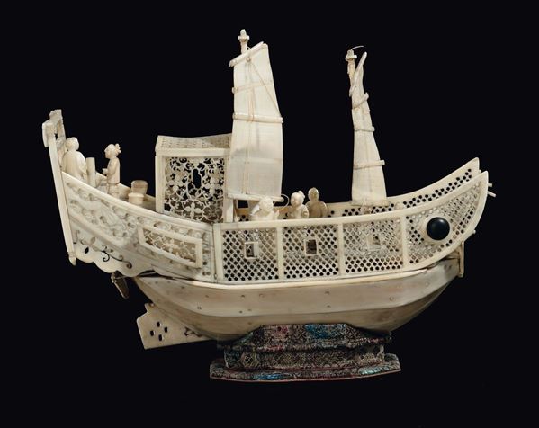 A carved and pierced ivory ship with characters, China, Qing Dynasty, 19th century