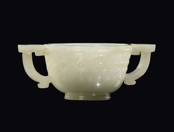 A small white jade two-handled ceremonial cup with archaic decoration, China, Qing Dynasty, 19th century