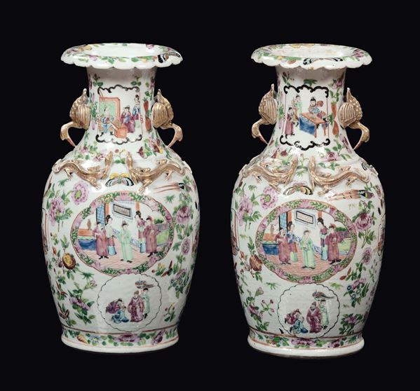 A pair of Canton polychrome porcelain vases court life scenes within reserves and gilt dragons in relief, China, Qing Dynasty, late 19th century