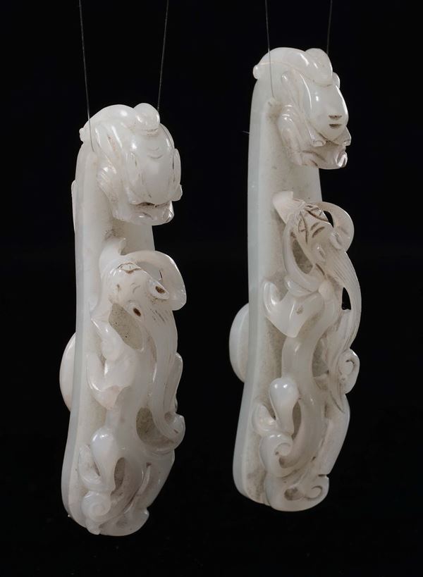 A pair of carved white jade and russet dragon belthooks, China, Qing Dynasty, Qianlong period (1736-1795)