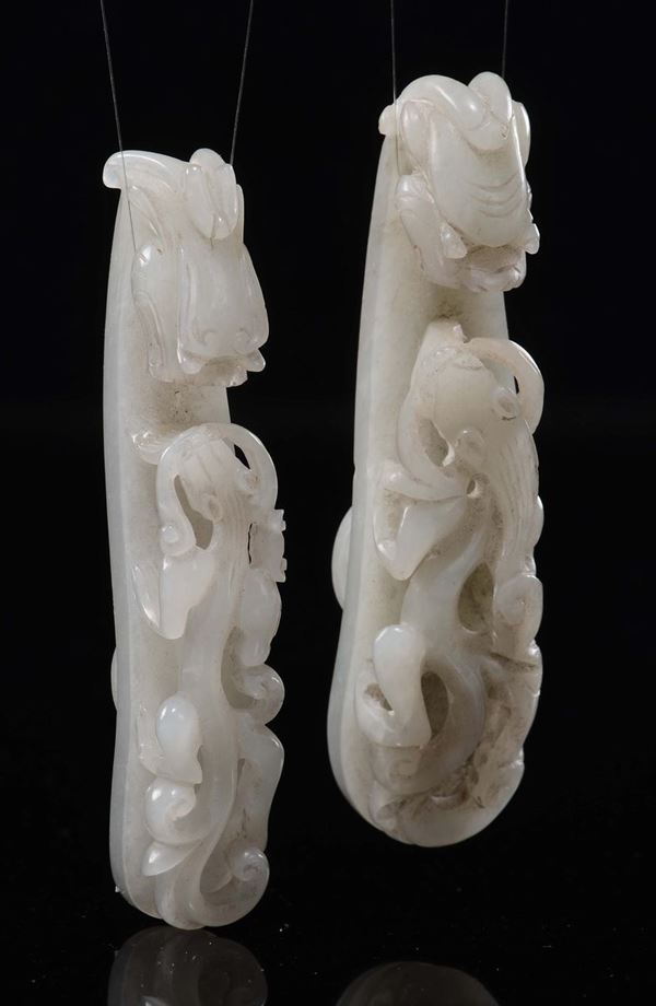 A pair of carved white jade and russet dragon belthooks, China, Qing Dynasty, Qianlong period (1736-1795)
