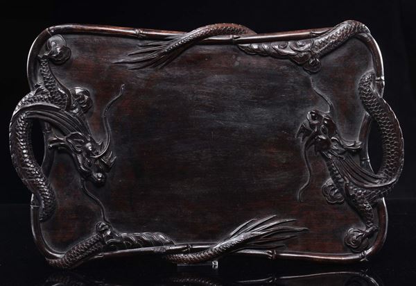 A carved wooden tray with dragons in relief, China, Qing Dynasty, 19th century
