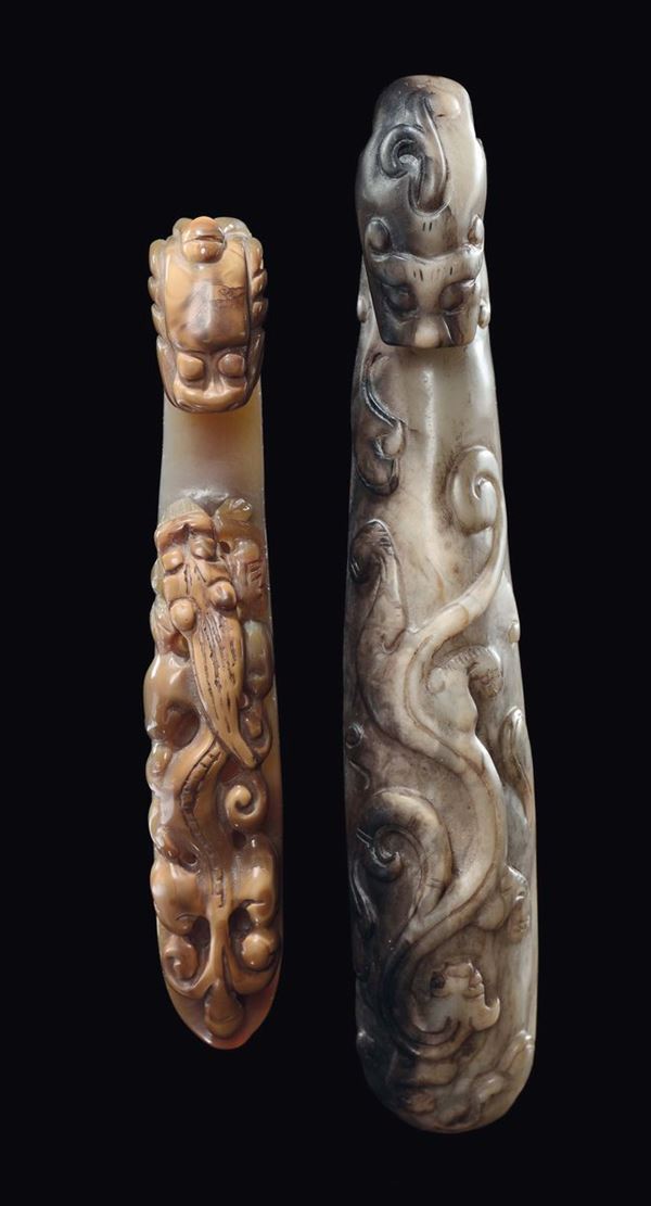 Two carved brown jade and russet dragon belthooks, China, Qing Dynasty, 19th century