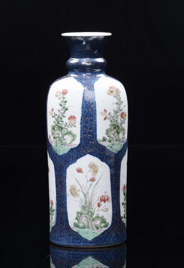 A small polychrome porcelain vase blue-ground with flowers  within reserves, China, Qing Dynasty, Kangxi Period (1662-1722)