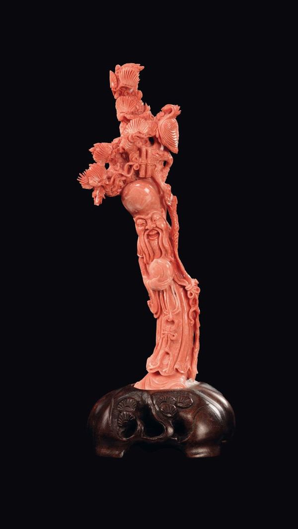 A carved coral figure of wise man with fruit and birds on stick, China, Qing Dynasty, late 19th century