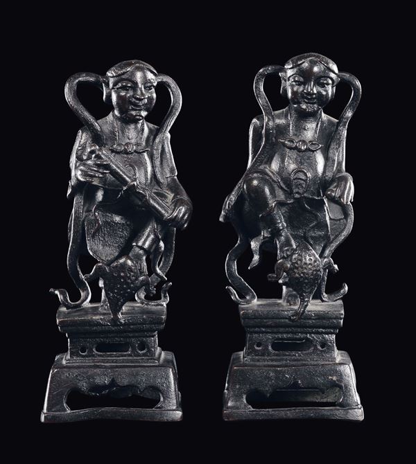 A pair of bronze dignitaries with frog, China, Ming Dynasty, 16th century