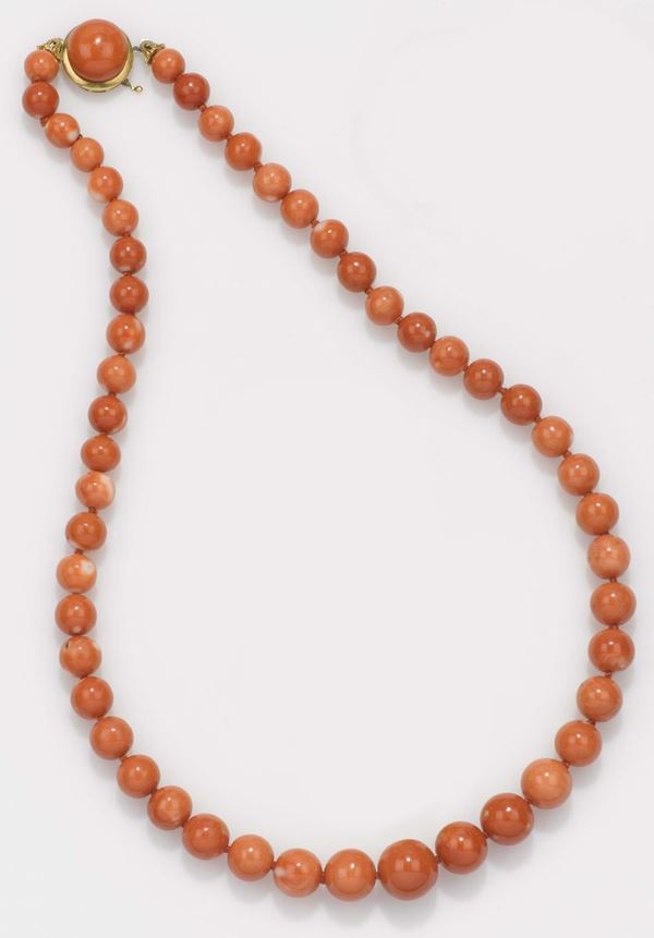 A coral necklace with a gold clasp