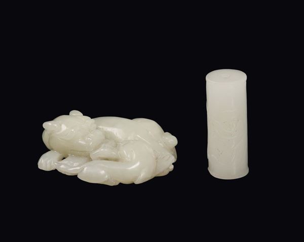 Two white jades, sleeping dogs group and a cylinder-shaped jade with fhishing child, China, Qing Dynasty, 19th century