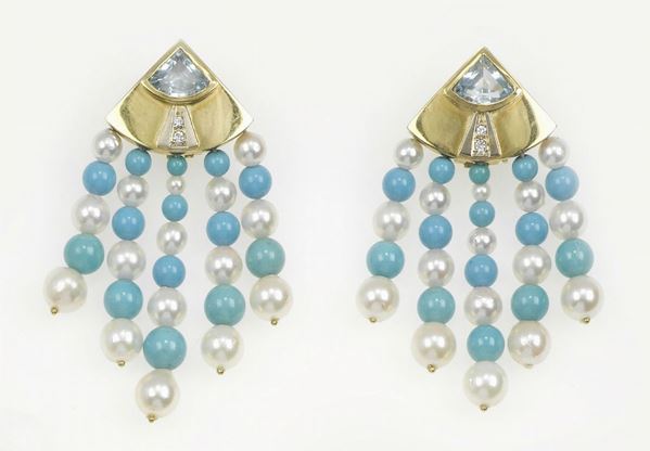 A turquoise and pearls pair of earrings
