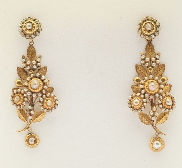 A pair of natural pearl and gold earrings