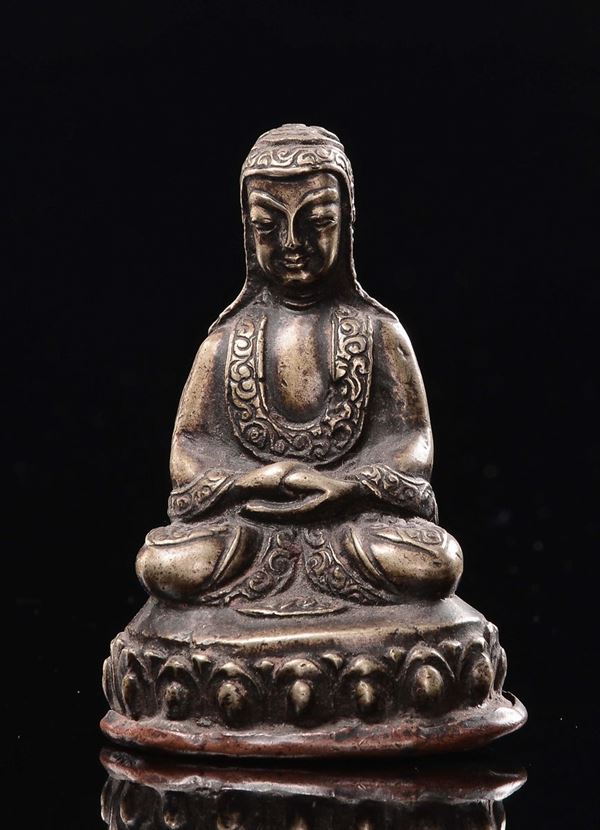 A small copper repoussè Lama seated on lotus flower, Tibet, 19th century