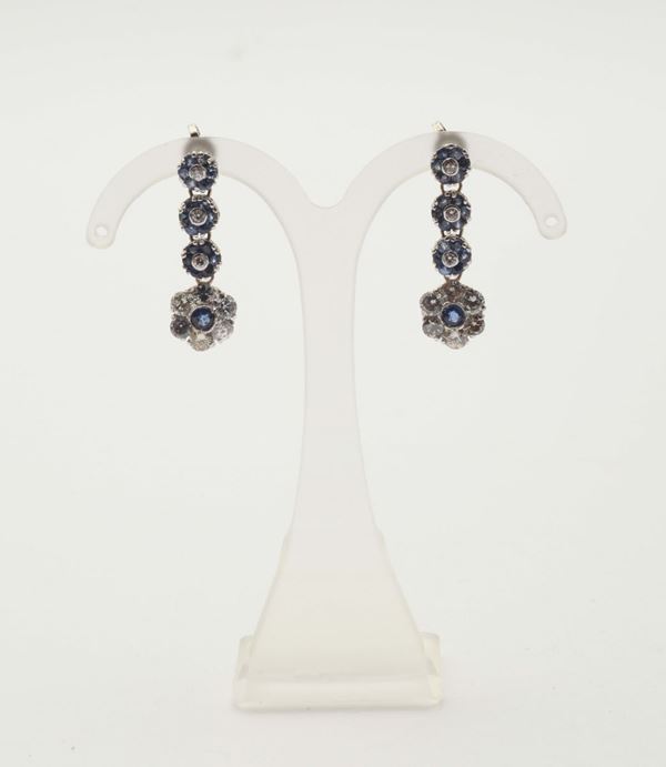 A pair of diamond and sapphire pendent earrings