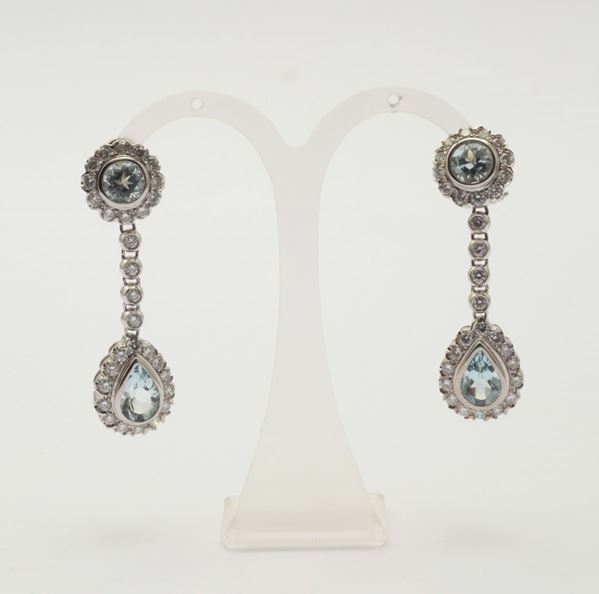 A pair of diamond and aquamarine pendent earrings
