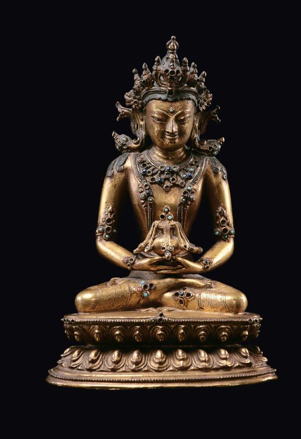 A gilt bronze Amitayus figure seated on a double lotus flower base, China, Qing Dynasty, 18th century [..]