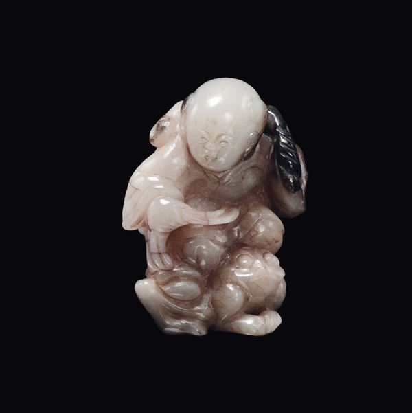A white and brown jade child with sack on a frog, China, Qing Dynasty, 18th century