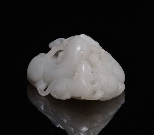 A white jade and russet three cats and butterfly group, China, Qing Dynasty, 18th century