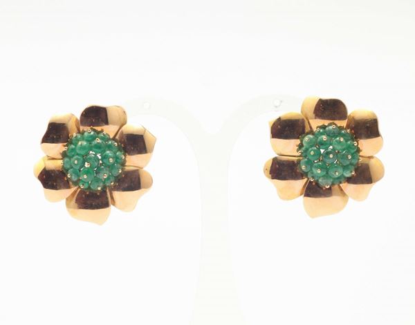 A pair of emerald and gold earrings