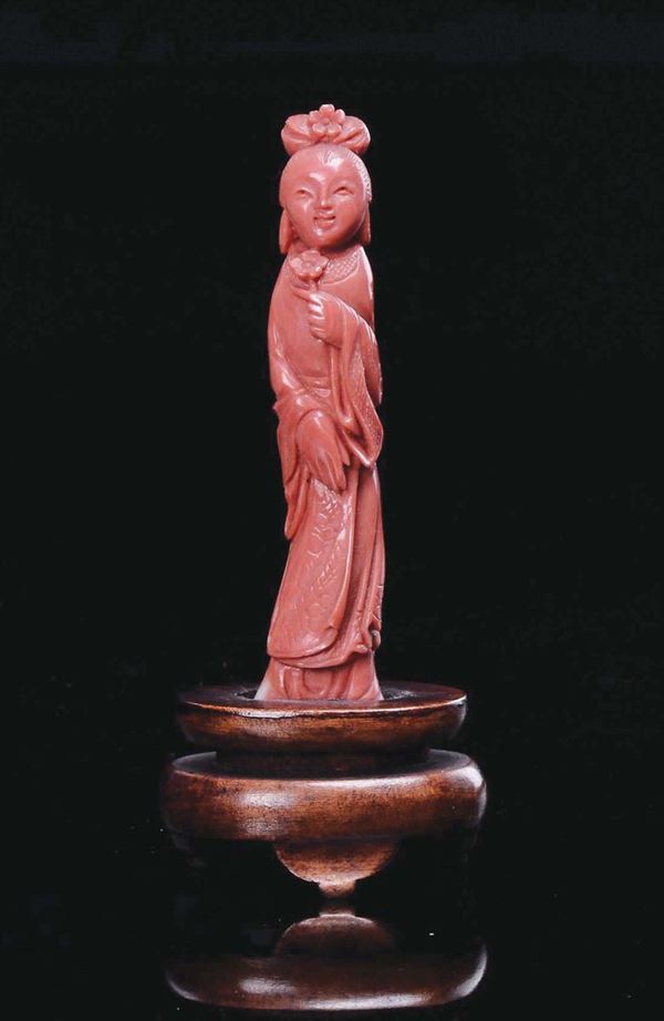 A small carved coral figure of Guanyin with flower in her hands, China, early 20th century