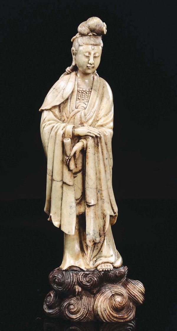 A carved stone Guanyin with parchment in her hand, China, Qing Dynasty, 19th century