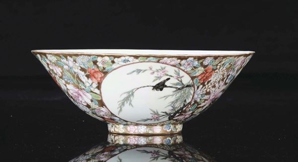 A gold-ground porcelain cup with birds and blossom branches within reserves, China, Qing Dynasty, 19th century