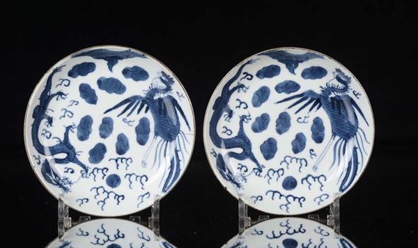 Coppia di piattini in porcellana bianca e blu con drago e fenice, Cina, Dinastia Qing, epoca Kangxi (1662-1722)