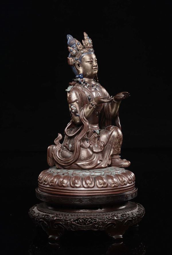 A polychrome porcelain kneeling Buddha, China, Qing Dynasty