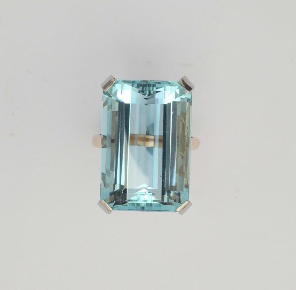 An aquamarine and gold ring